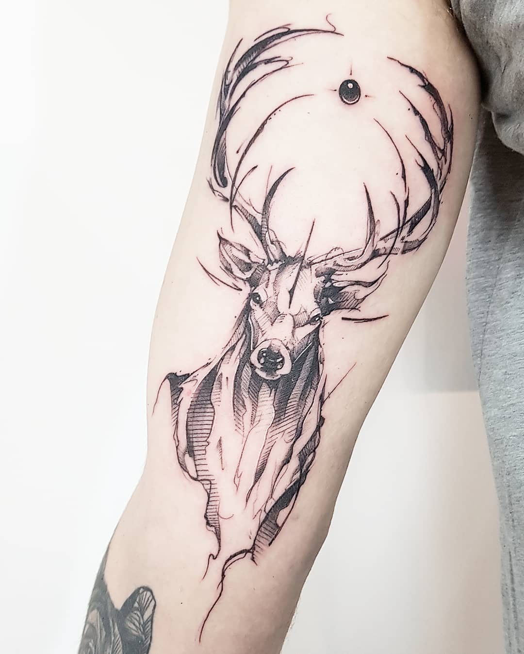 Detailed sketch tattoo showcasing cross-hatching, artistic texture, and illustrative linework