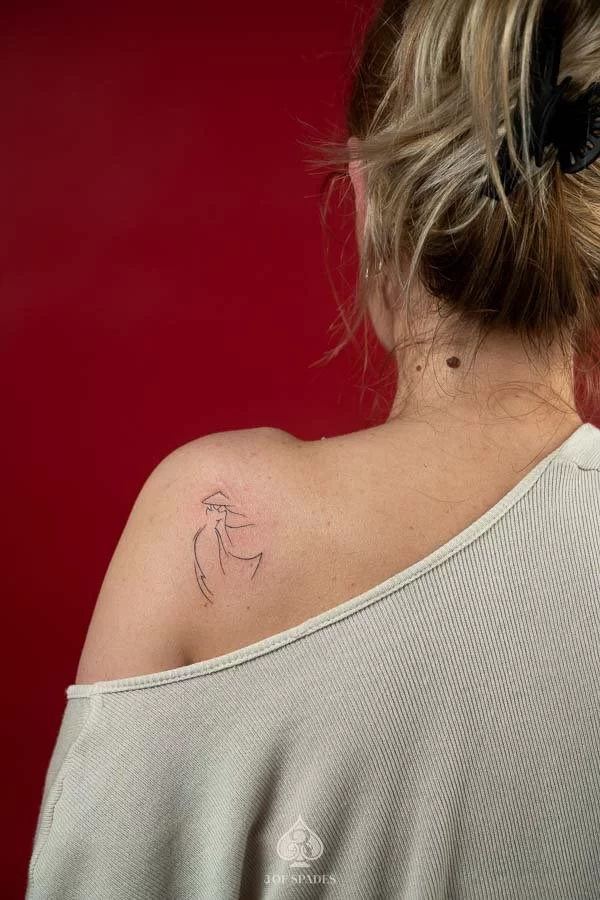 Minimalist Ao Dai fine line tattoo symbolizing Vietnamese identity and heritage
