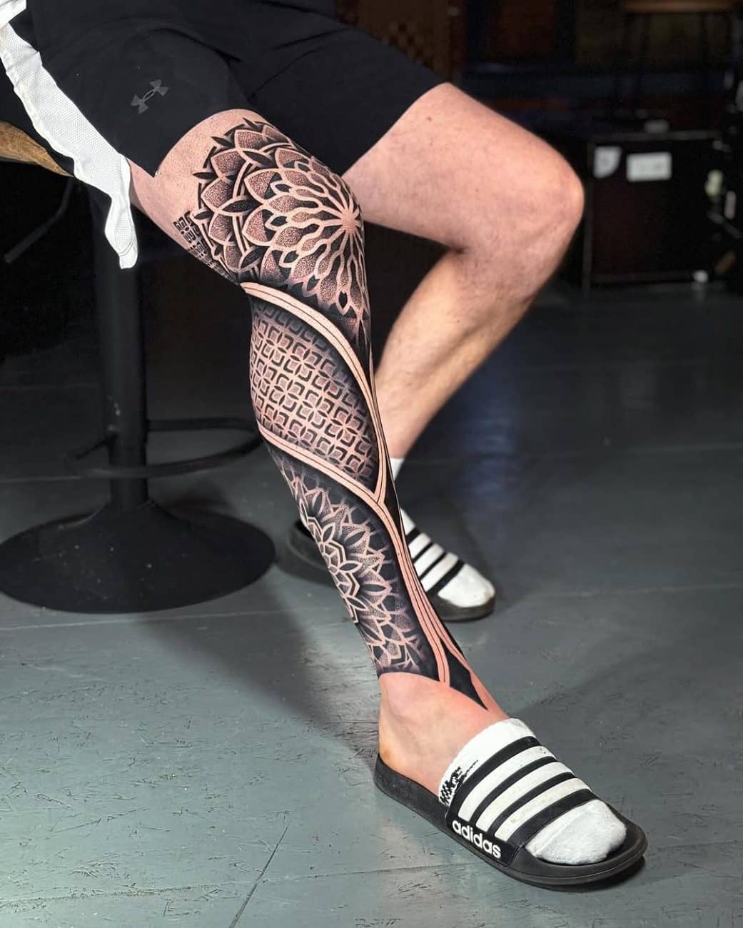 Full geometric leg sleeve tattoo demonstrating large-scale pattern flow and anatomical placement