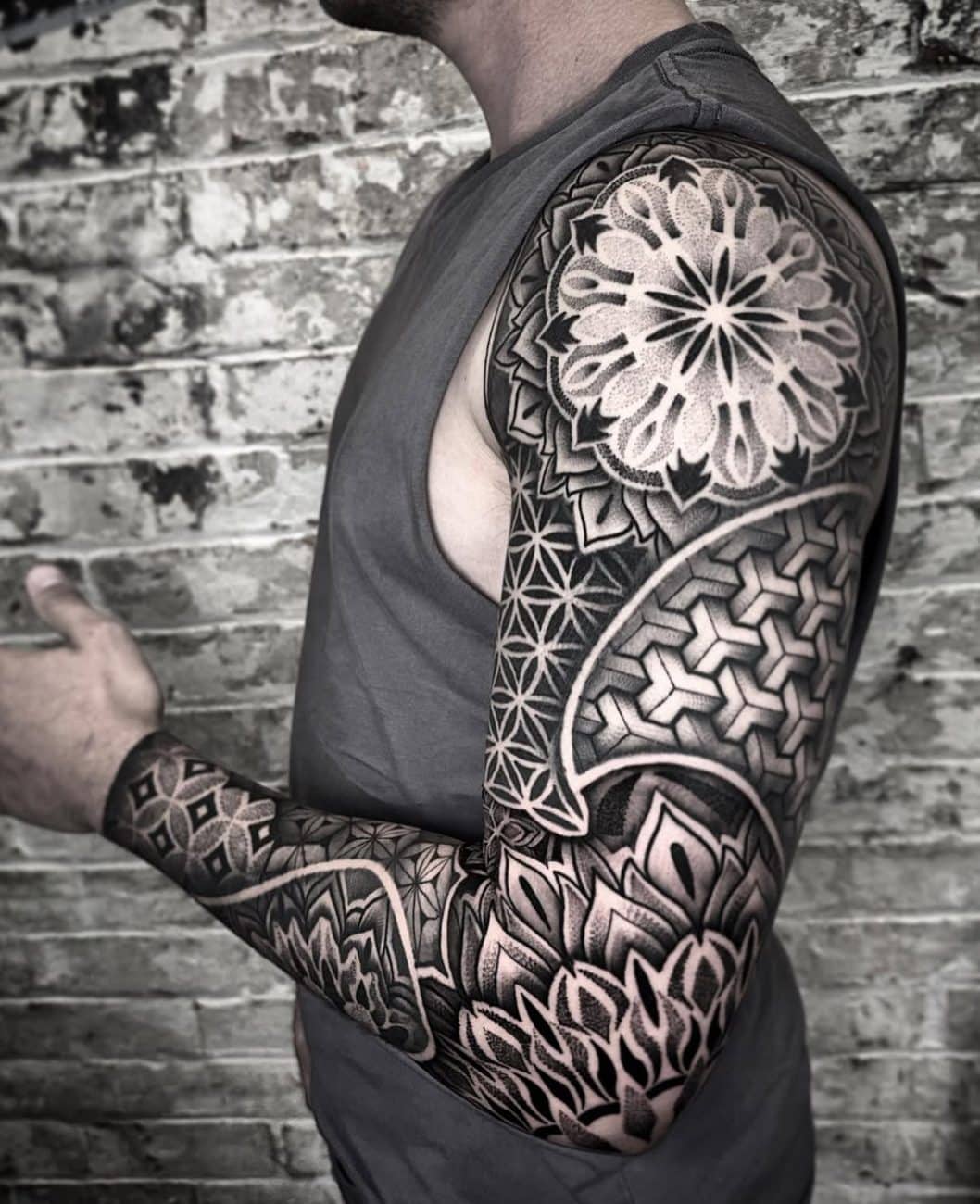 Geometric tattoo sleeve featuring mandala and sacred geometry patterns