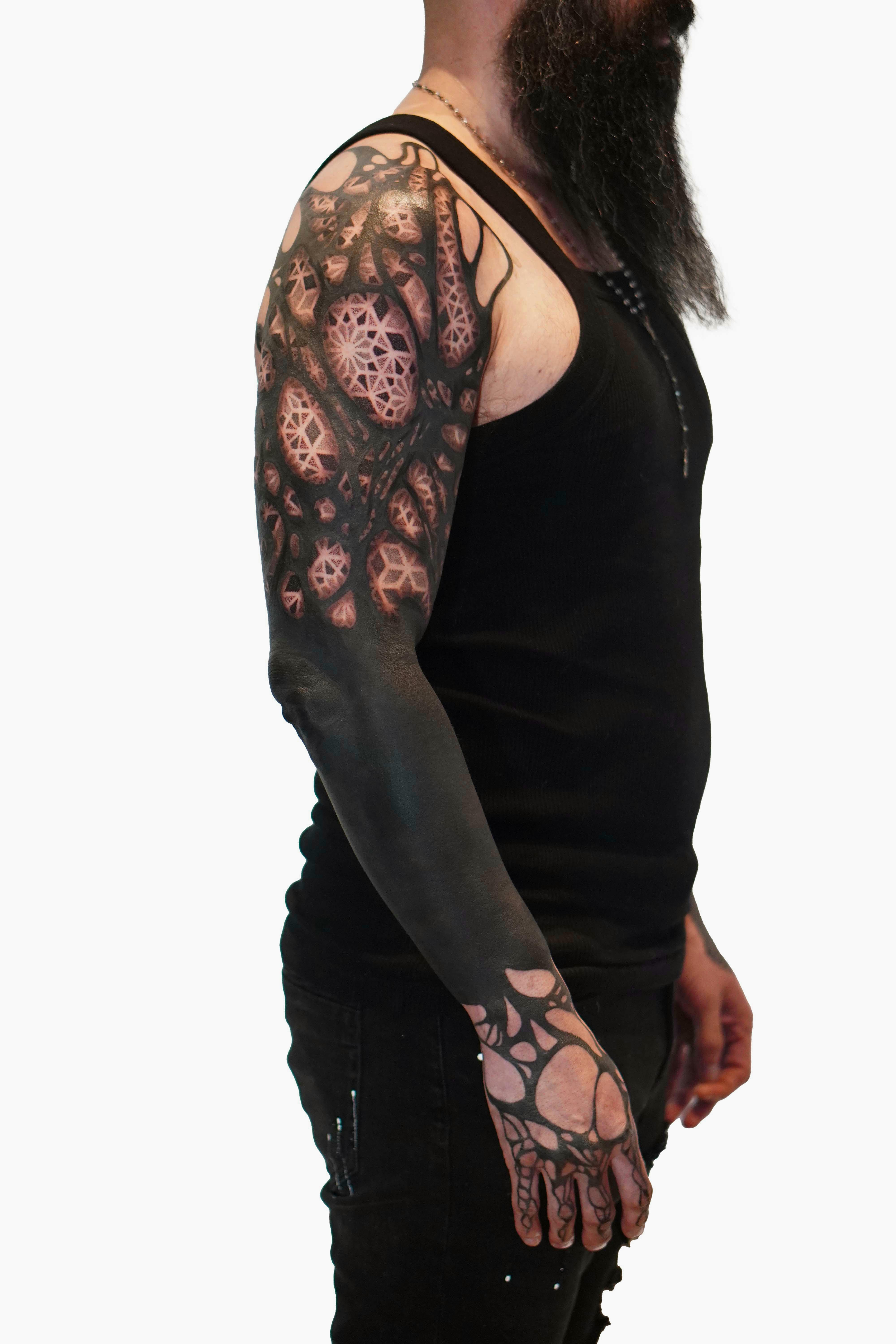 Heavy Blackwork Tattoo Guide: Styles, Pain, Cost & Healing 7 Heavy blackwork tattoo sleeve with advanced saturation techniques