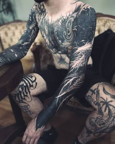 Comparison of blackwork tattoo cover up techniques including geometric patterns and negative space