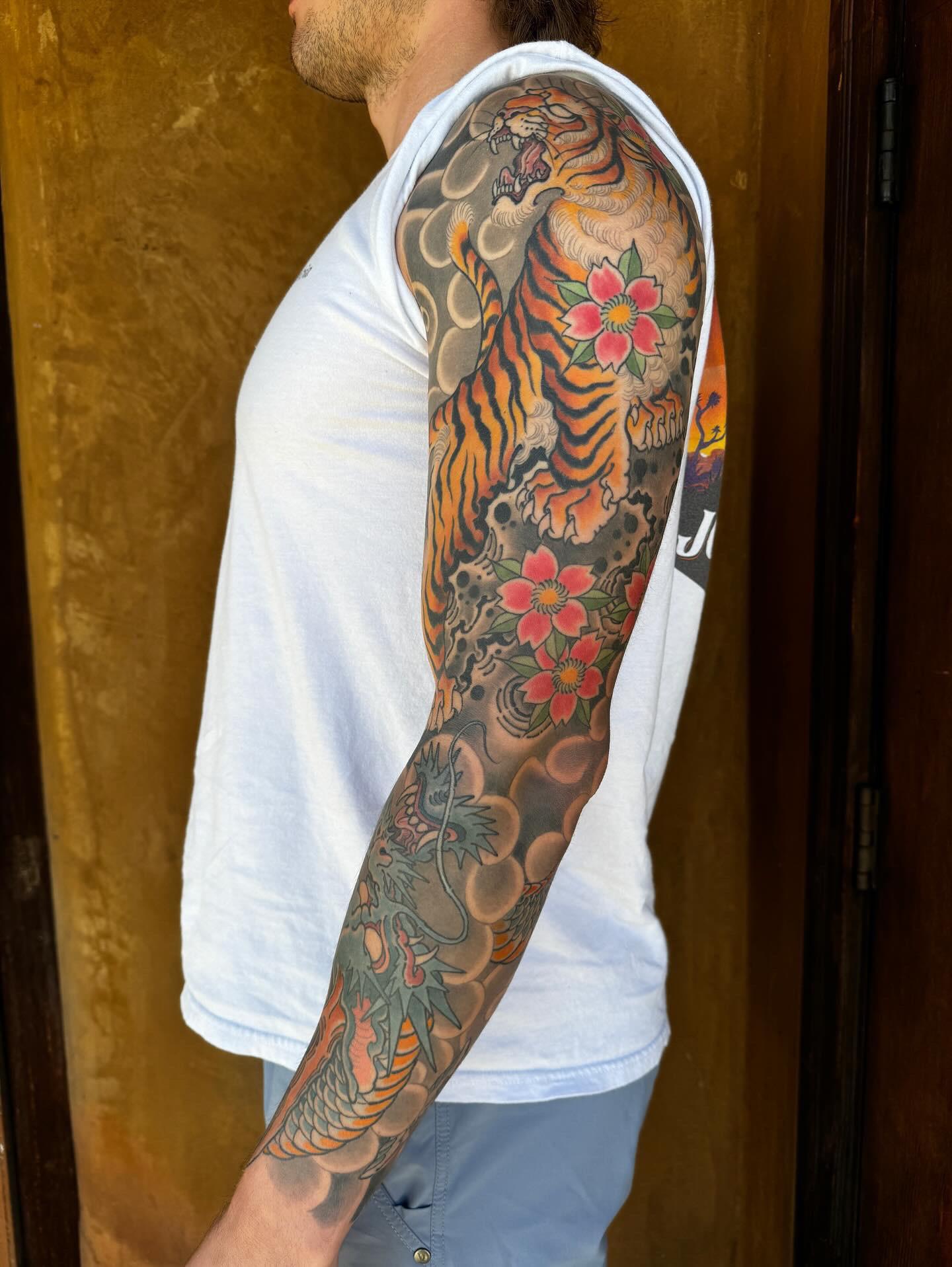 Asian Tiger Dragon Sleeve Tattoo: Meaning, Designs & Ideas tiger dragon sleeve by pete vaca at full circle tattoo v0 dnl5ijh48fdc1